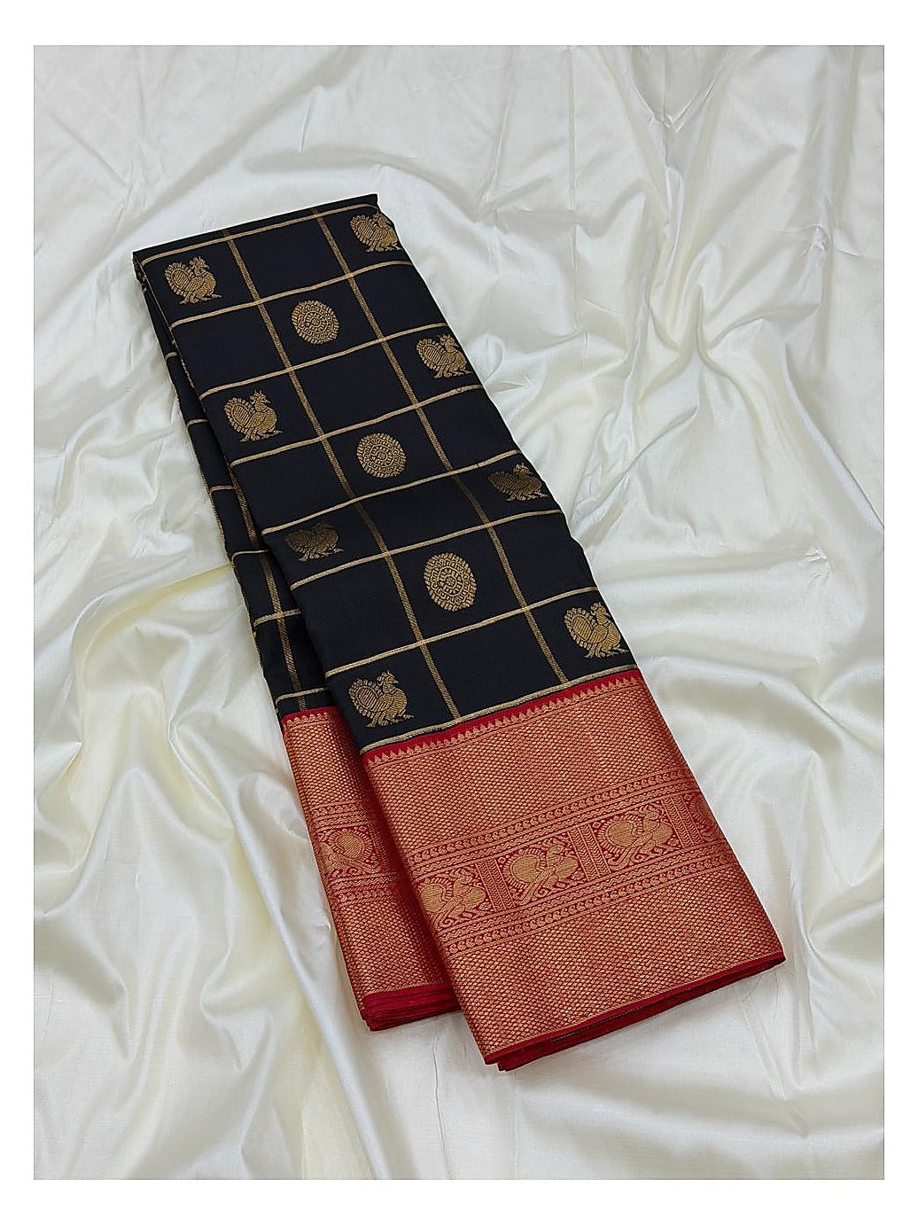 Navy blue saree body with gold-toned checks and woven motifs alongside a broad red border