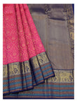 Draped view of the pink saree showing zari motifs, navy border, and multicolour woven stripe accents