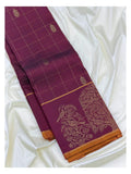 Angled view of the magenta handwoven Kanchipuram silk saree with gold line checks, butta motifs and bird motif border