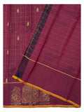 Magenta handwoven Kanchipuram silk saree showing the body drape, gold butta motifs and bird motif border