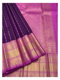 Deep purple handwoven Kanchipuram silk saree with magenta-gold pallu and broad elephant motif border