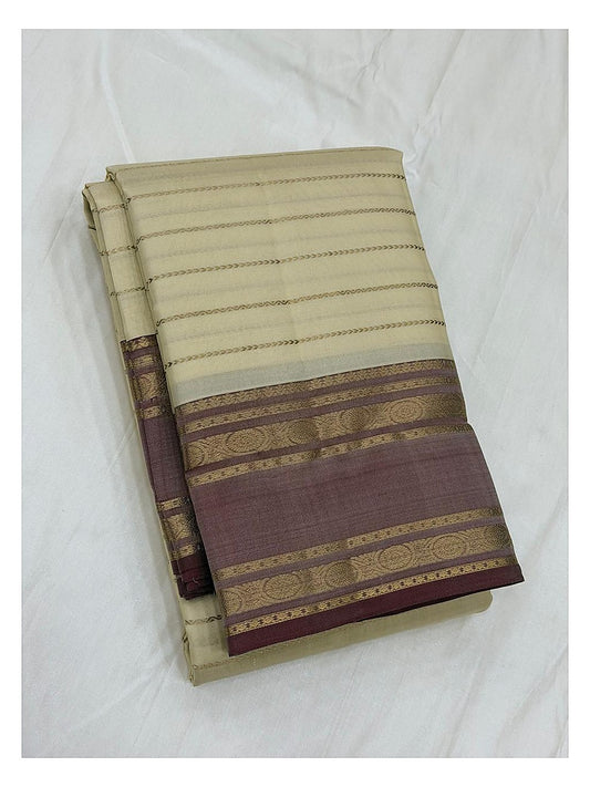 Pure silk saree in cream with mauve border and gold woven detailing folded on white background