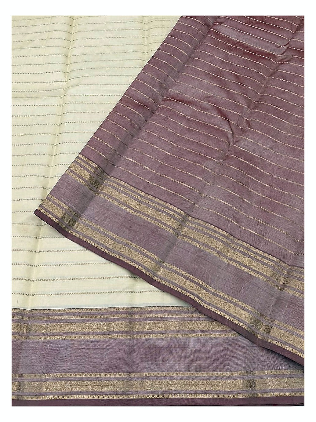 Close view of cream saree body with striped mauve pallu and gold woven border