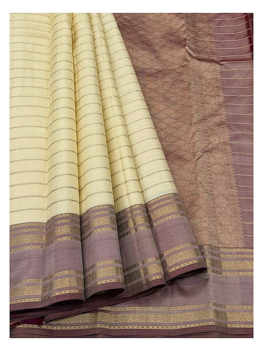 Pure silk saree drape showing cream body, mauve border, and woven pallu