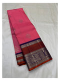 Bright pink saree body with silver-toned buttas and folded purple contrast border