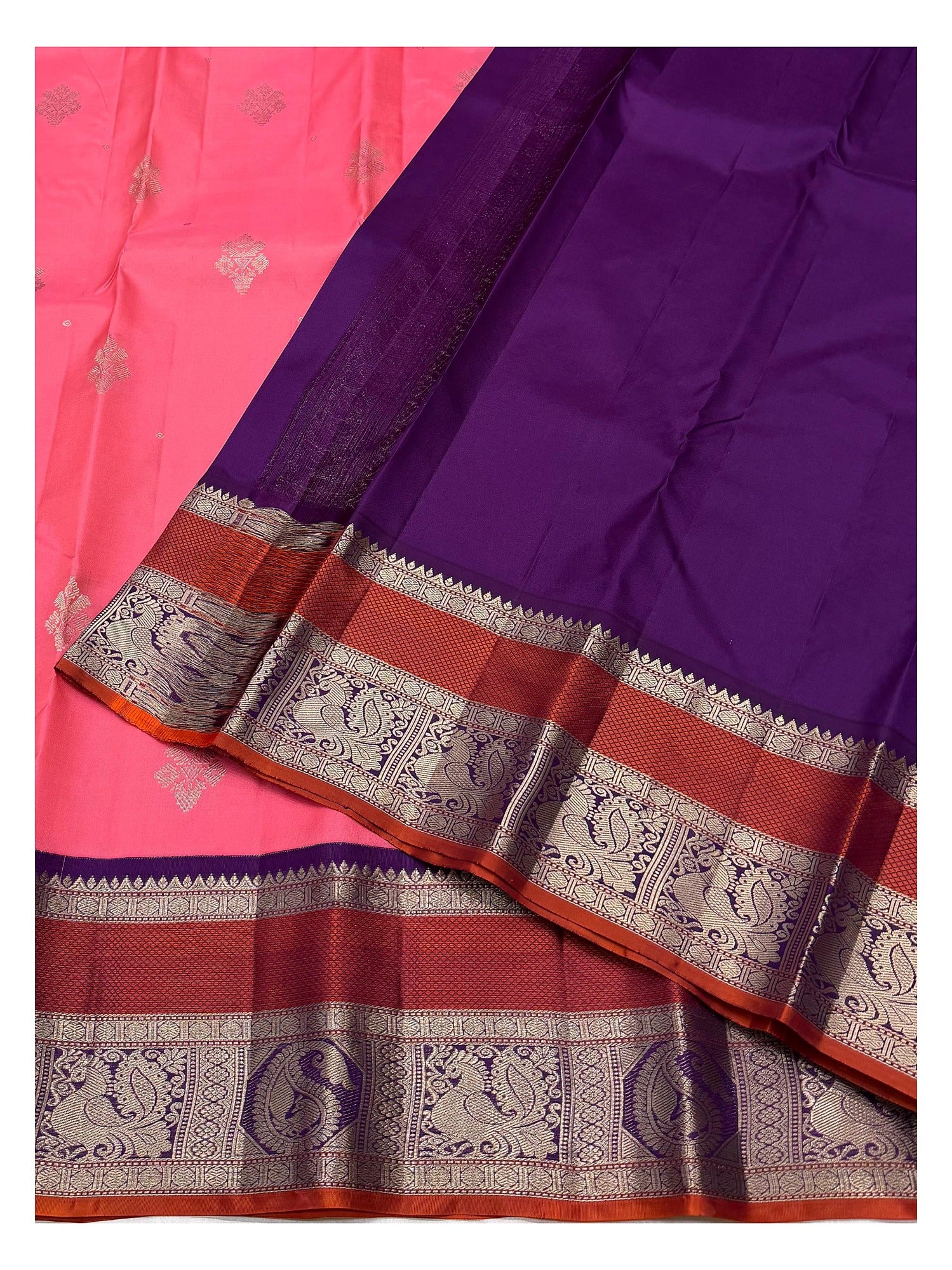 Deep purple pallu and peacock panel border on bright pink pure silk saree