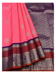 Bright pink pure silk saree drape with silver-toned buttas and purple peacock pallu