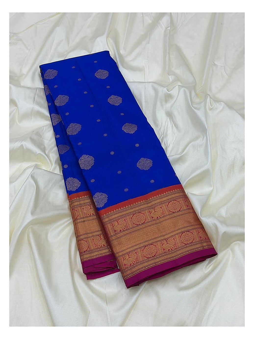 Royal blue saree body with metallic woven motifs and broad contrast border