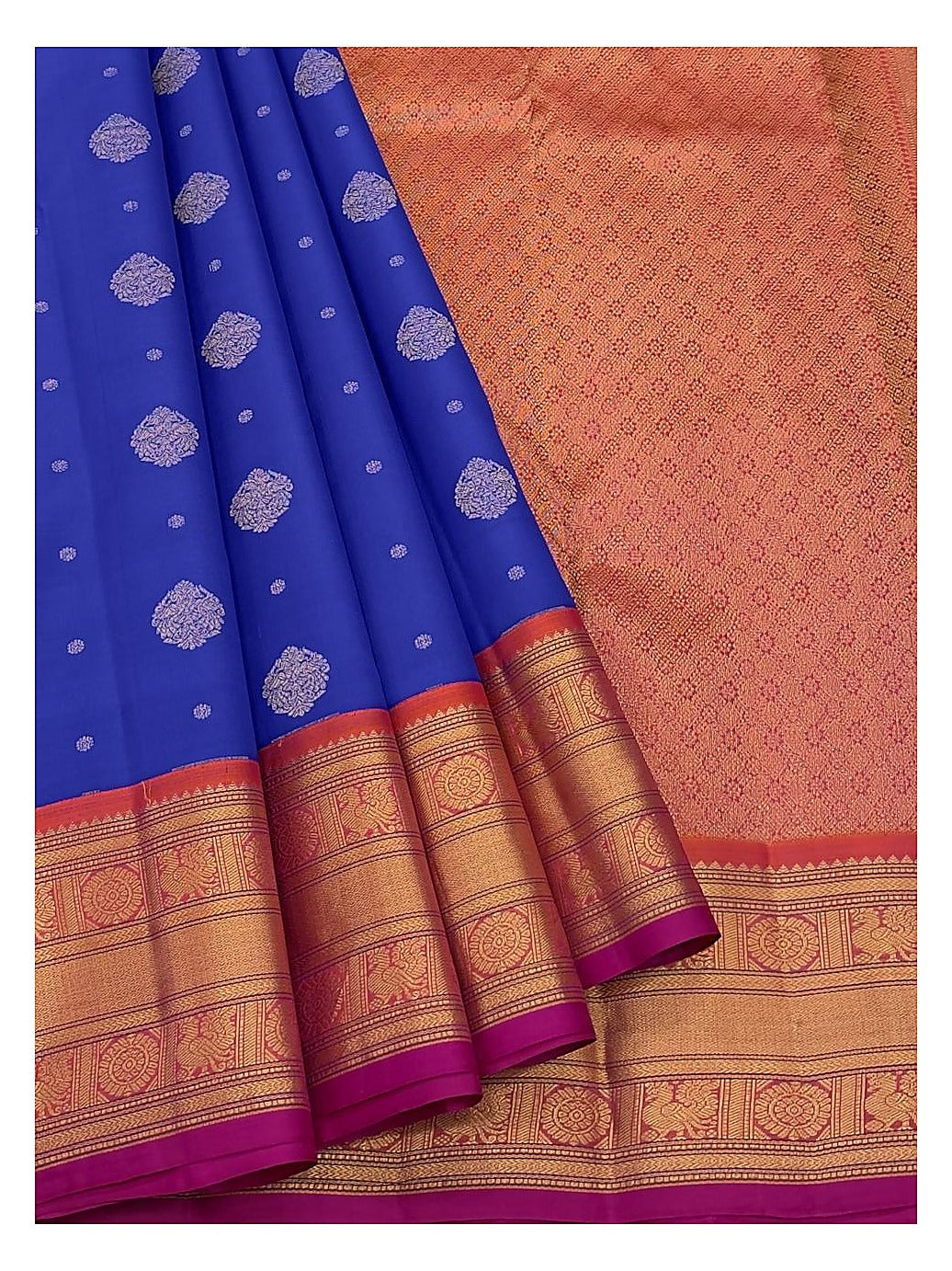 Royal blue saree with folded pleats and matching magenta blouse piece