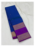 Royal blue saree body with fine pinstripes, small butta motifs, and folded magenta contrast pallu