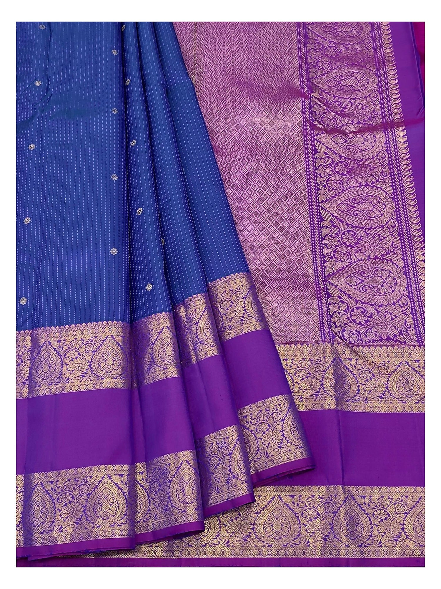 Royal blue handwoven Kanchipuram silk saree drape showing the magenta contrast pallu and woven border details