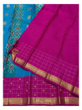 Contrast magenta blouse piece with zari border beside the saree border