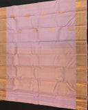 Beautiful light pink floral buttas adorn these traditional Kancheepuram silk sarees with self-designed borders