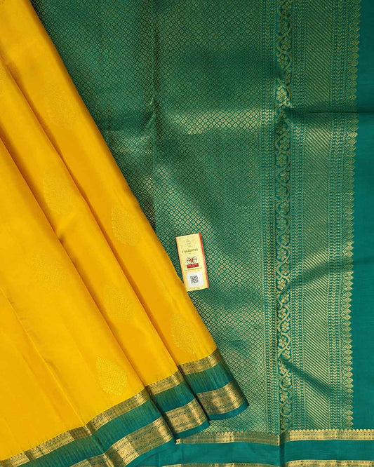 Bright yellow Kancheepuram silk sarees with contrasting border and intricate pallu